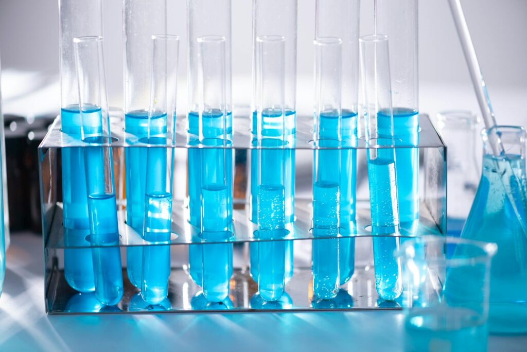 Close-up of blue liquid in test tubes for chemistry experiments in a laboratory setting.