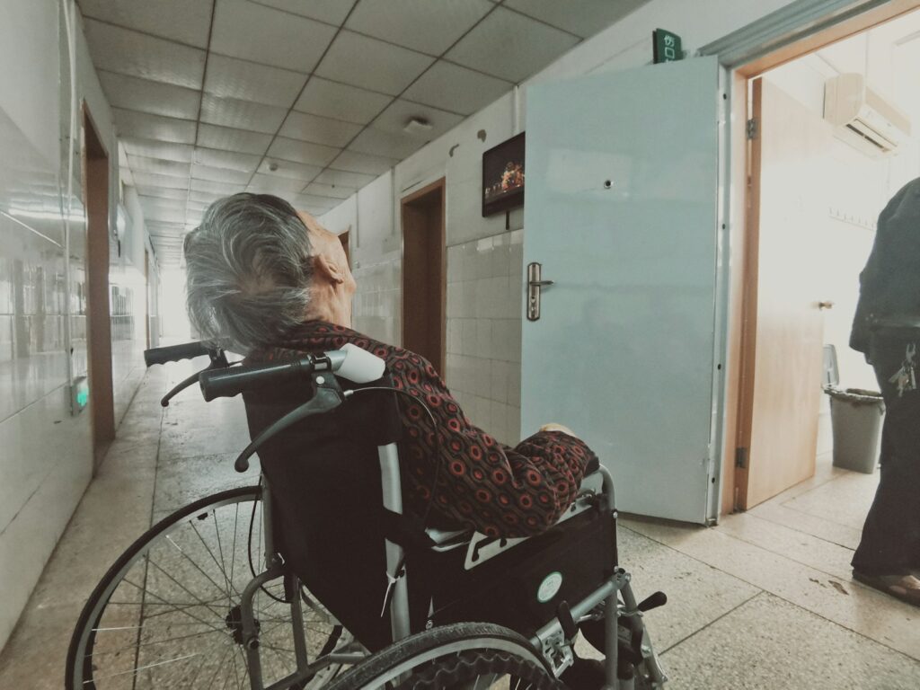 woman in black and white long sleeve shirt sitting on black wheelchair